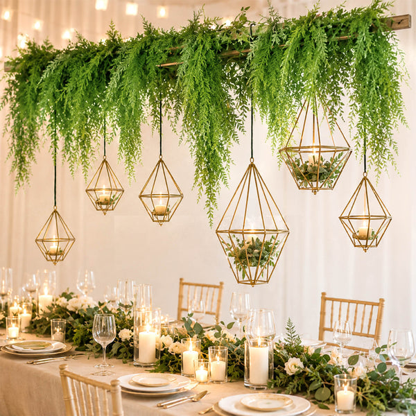 Elegant greenery wedding table with hanging candle lanterns and candles