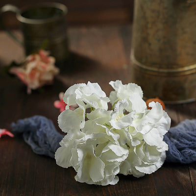 White floral arrangement on a rustic wooden surface.
