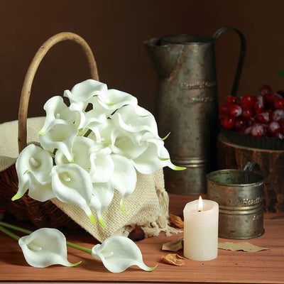 White calla lilies in a basket with a candle and rustic decor.