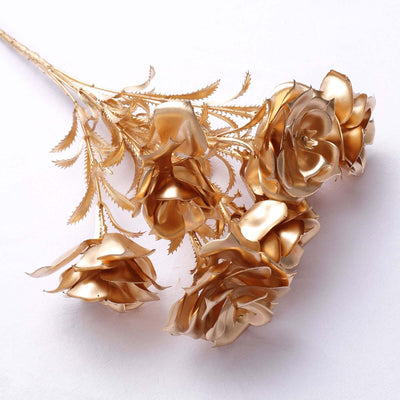 Gold artificial roses bouquet on white background