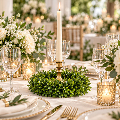 Elegant white and gold wedding table setting with candles and floral centerpieces