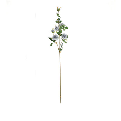 Artificial blue rose stem with green leaves on a white background