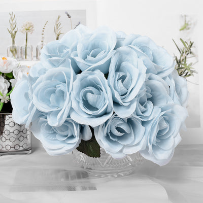 Light blue artificial rose bouquet in a crystal vase.