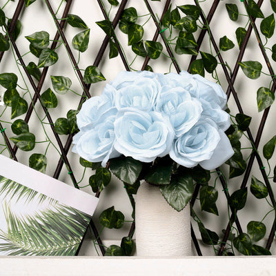 Light blue artificial rose bouquet in a textured white vase.
