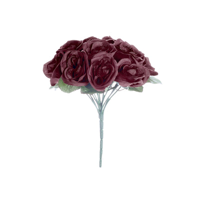 Artificial burgundy rose bouquet with green leaves, studio shot.