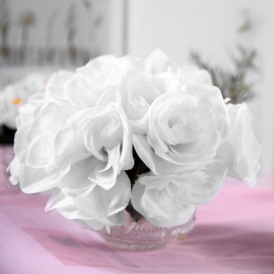 White artificial rose bouquet in a clear vase.