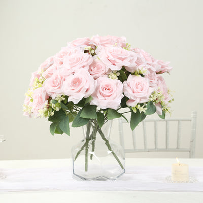 Pink roses in a clear vase, beautifully arranged for a fresh floral display.