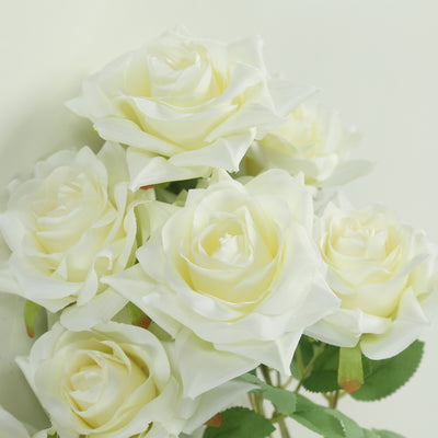 Artificial white roses bouquet on a plain background.
