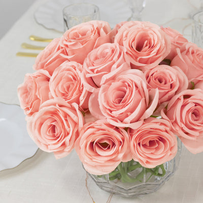 Bouquet of soft pink roses in a glass vase.