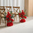 Red rose floral aisle decorations beside wooden chairs in a wedding venue