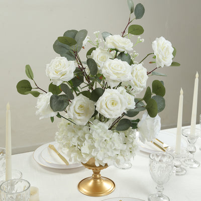 White floral arrangement in a gold vase for elegant table decor.