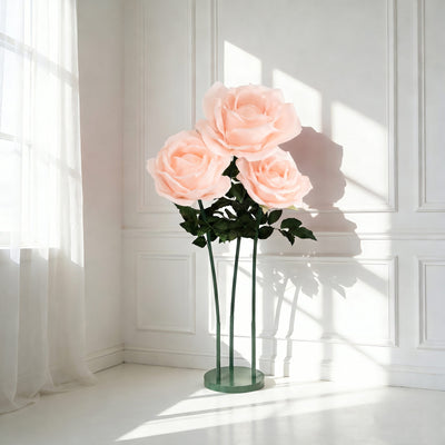 Oversized pink rose floor lamp in a bright white room with sunlight shadows