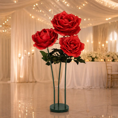 Large red rose centerpiece on stand in elegant wedding reception decor