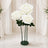 Large white artificial roses on stand in elegant wedding decor setting