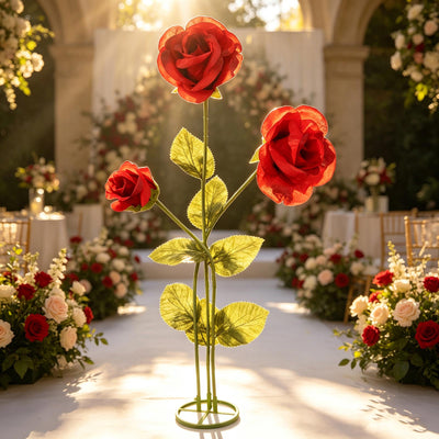 Three red roses on a stem in a romantic floral wedding aisle decor