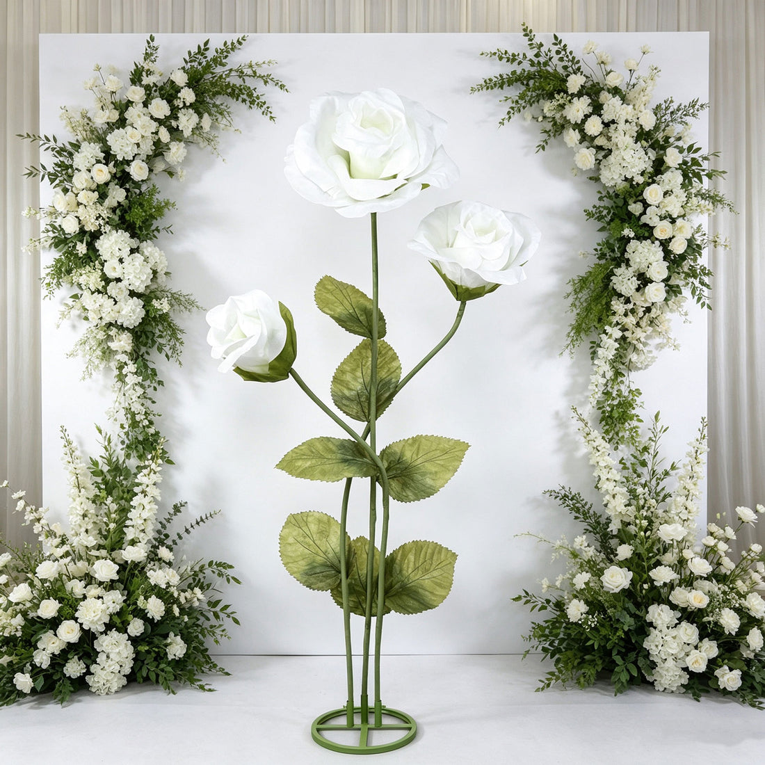 Elegant white rose floral wedding backdrop with green foliage arch and stand