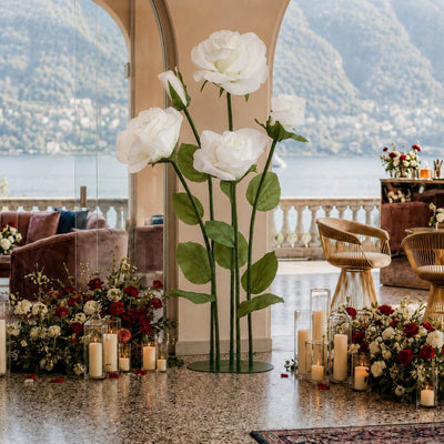 Elegant lakeside wedding floral decor with white roses and candles