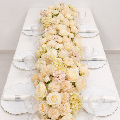 Elegant floral table centerpiece with white plates and glass goblets