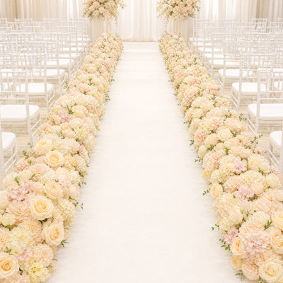 Elegant wedding aisle with white chairs and pastel floral arrangements