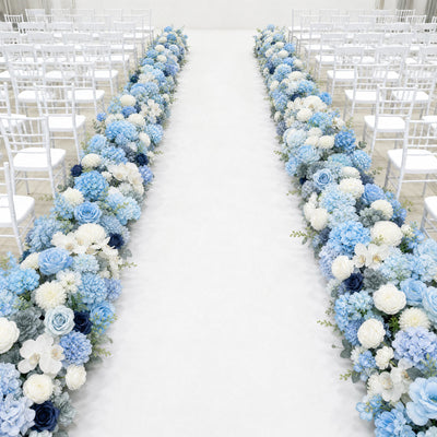 Elegant wedding aisle with blue and white floral arrangements and white chairs
