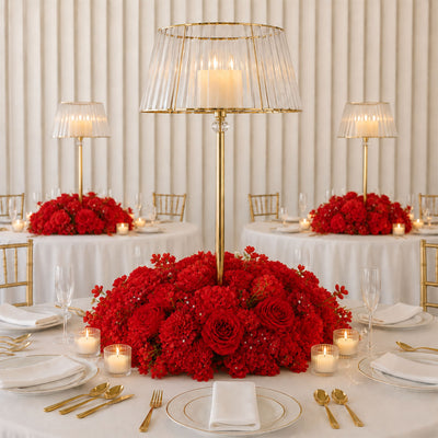 Elegant red floral wedding table centerpiece with gold candle lanterns