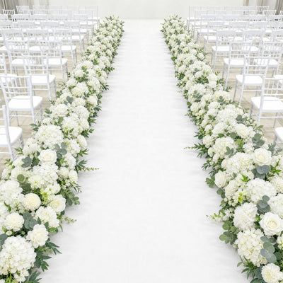 White wedding aisle with floral arrangements and white chairs
