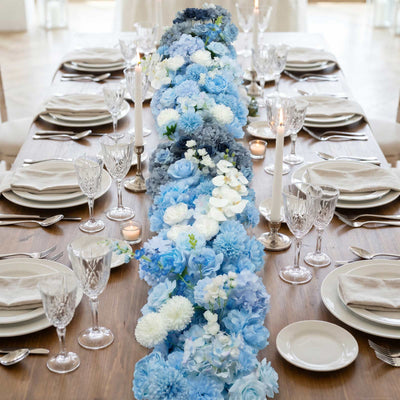 Elegant blue floral table centerpiece on a formal dining table setting