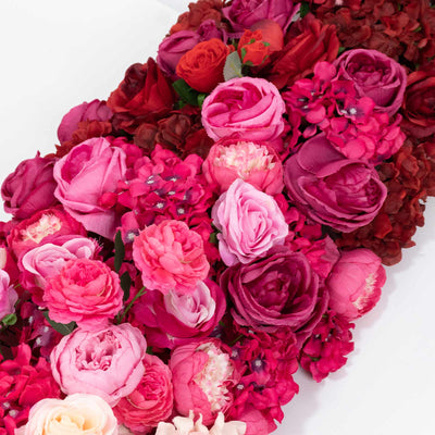 Pink and magenta rose floral arrangement with hydrangeas on white background