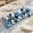 Elegant blue floral wedding table centerpiece with crystal glassware and candles
