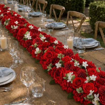 Elegant outdoor wedding table with red floral centerpiece and candles