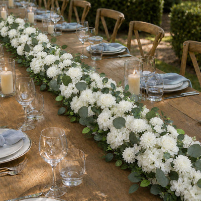 Elegant outdoor wedding table with white floral centerpiece and candles
