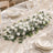 Elegant white floral table centerpiece with gold-rimmed dinnerware and glassware