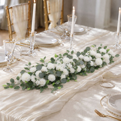 Elegant wedding table setting with white floral centerpiece and gold accents
