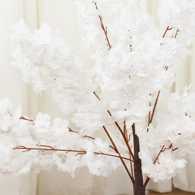 White artificial cherry blossom tree with delicate petals and brown branches.