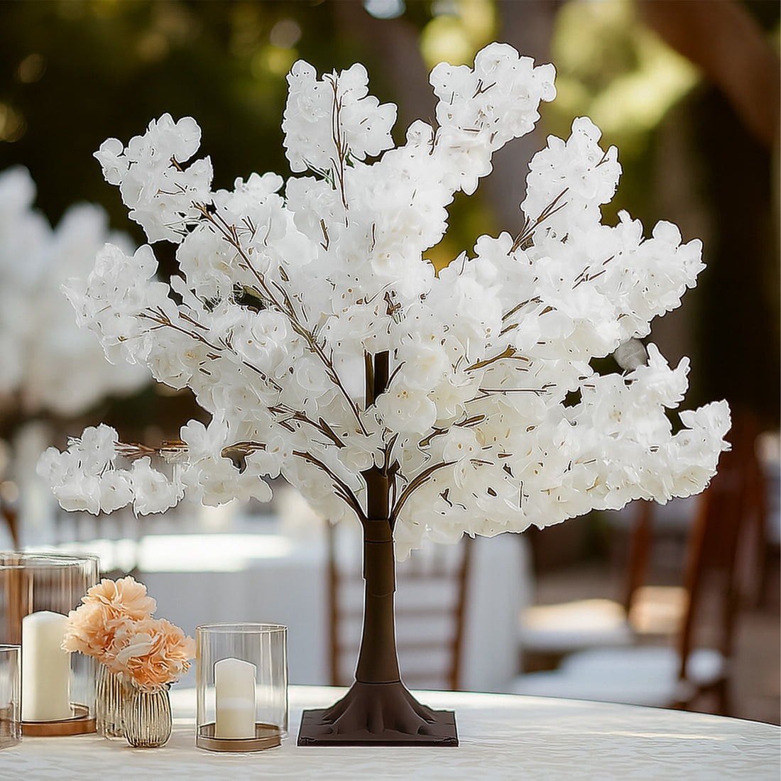 White floral tree centerpiece for elegant table decor.