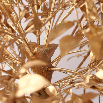 Golden decorative tree branches close-up with metallic leaves