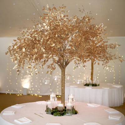 Elegant gold leaf tree centerpiece with candles, perfect for weddings and events.