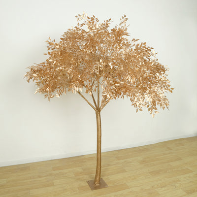 Gold metallic decorative tree with detailed leaves on a plain background.