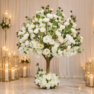 Elegant white floral tree centerpiece with candles in a wedding setting