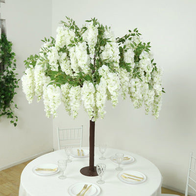 Artificial white flower tree centerpiece for elegant table decor.