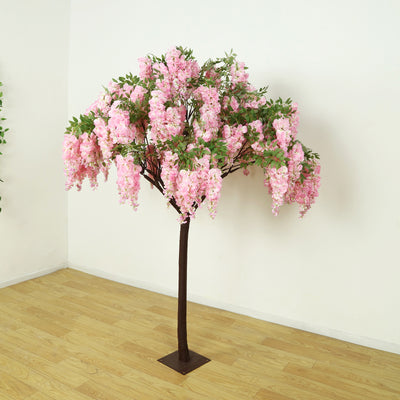 Artificial pink flowering tree with a sturdy trunk and base.