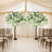 Artificial floral wisteria trees for wedding decor in a serene indoor setting.