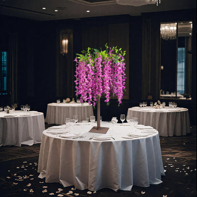 Elegant floral centerpiece on a round table in a sophisticated dining setting.