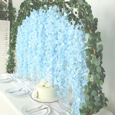 Blue floral backdrop with greenery for event decoration.