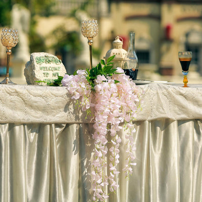 Elegant floral arrangement with candles and decor on a table setting.