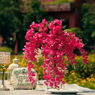 Pink floral arrangement in a garden setting with decorative elements.