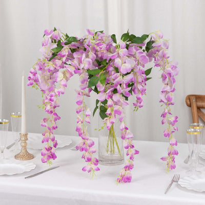 Vibrant purple orchid arrangement in a vase on a dining table.