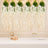 Elegant white floral wall decor with champagne glasses and gift boxes on a table