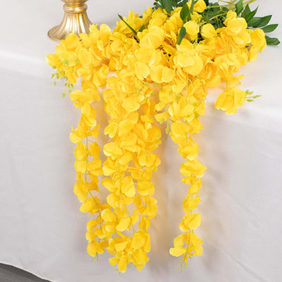 Artificial yellow flower garland draping elegantly on a table.