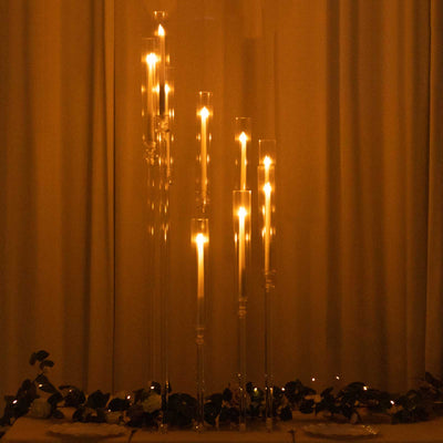 Elegant tall candle holders with glowing candles for ambient lighting.